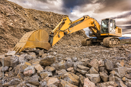 Large excavator moving stone in an open-air mine in Spain photo