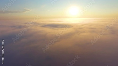 Flight over the clouds at dawn.