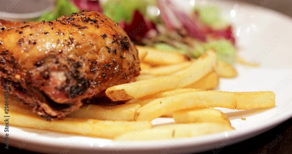 Having french fries and grilled chicken in restaurant Having french fries and grilled chicken in restaurant