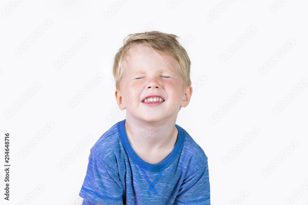Three years old kid and emotions, close-up portrait of happy smiling child with with closed eyes at white background Three years old kid and emotions, close-up portrait of happy smiling child with with closed eyes at white background
