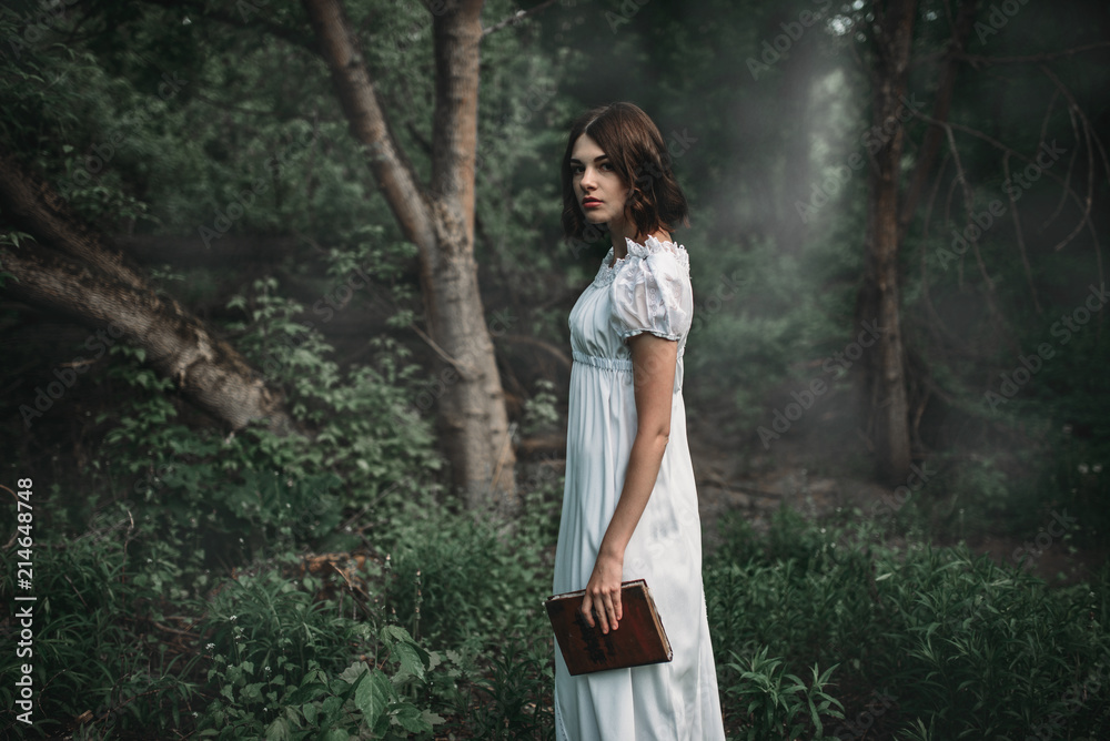 Female victim in white dress holds book in hand Female victim in white dress holds book in hand