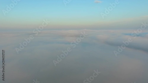 Flight over the clouds at dawn.