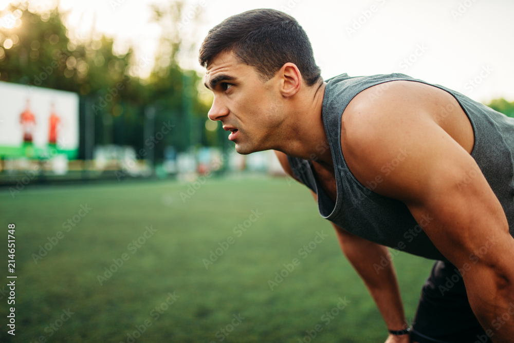 Muscular male athlete prepares for the training