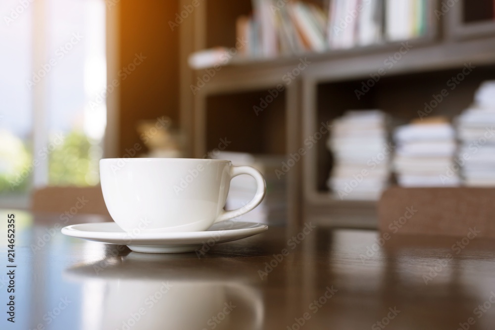 cup coffee on table in cafe. background style library book shelf Morning sunlight. cup coffee on table in cafe. background style library book shelf Morning sunlight.