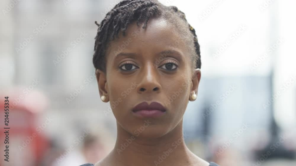 Portrait of attractive black female looking to camera before smiling Portrait of attractive black female looking to camera before smiling