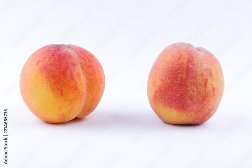 Peaches on a white background, two peaches isolated, orange nectarine close-up, blank for a designer, vegetarian food for breakfast, orange fruit for juice Peaches on a white background, two peaches isolated, orange nectarine close-up, blank for a designer, vegetarian food for breakfast, orange fruit for juice
