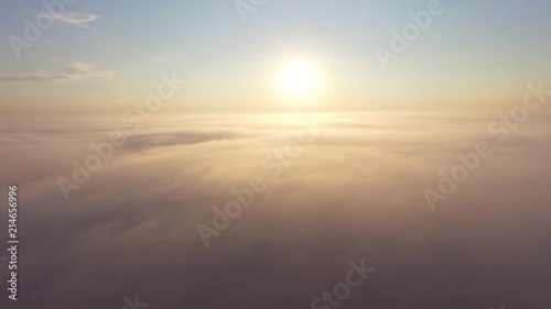 Flight over the clouds at dawn.