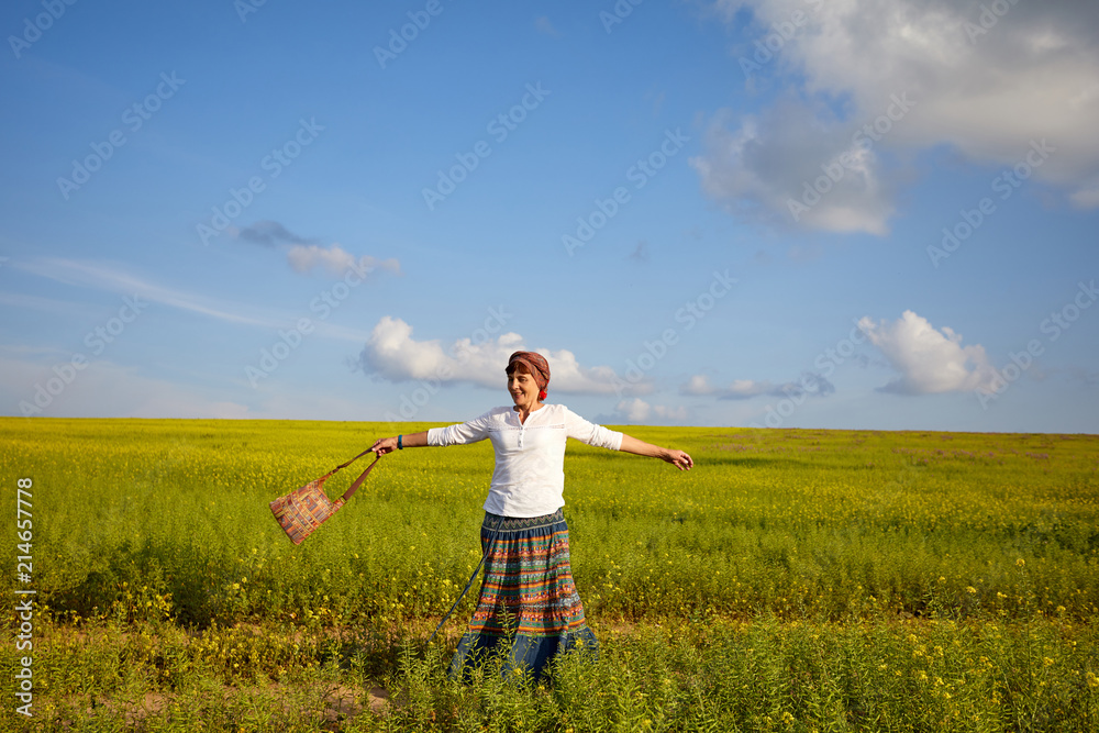 A young woman is playing on a flowering meadow. Enjoy life A young woman is playing on a flowering meadow. Enjoy life