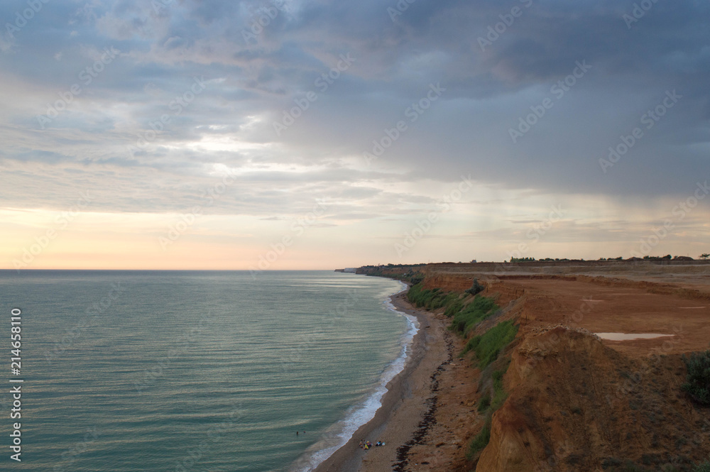 Black Sea coast. the shore consists mainly of land and can collapse. over the coast hung thunderclouds Black Sea coast. the shore consists mainly of land and can collapse. over the coast hung thunderclouds