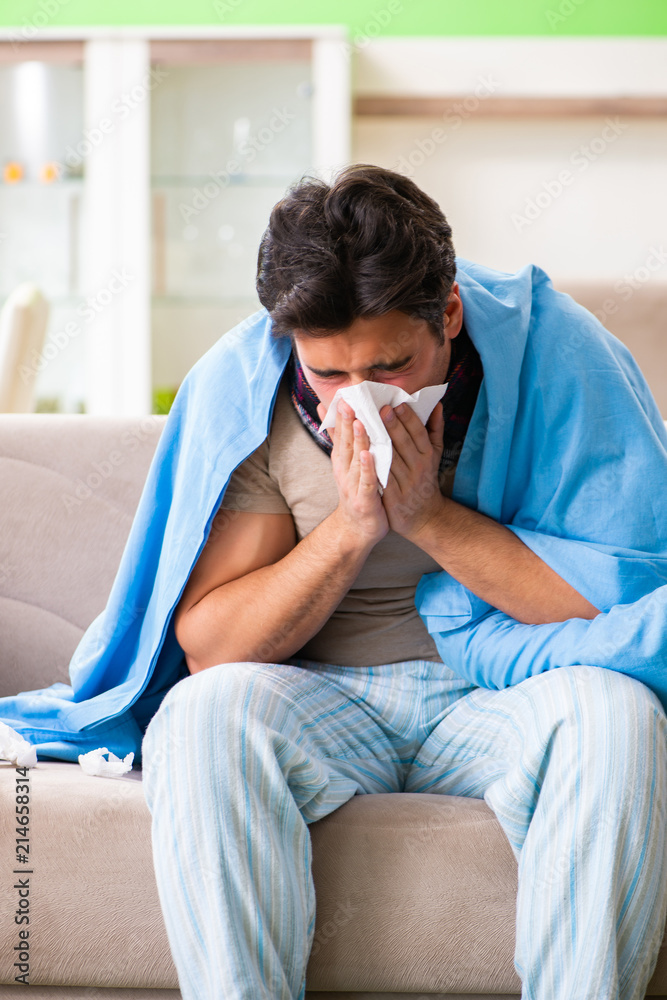 Sick young man suffering from flu at home Sick young man suffering from flu at home