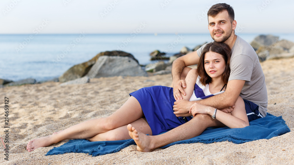Young loving couple resting and hugging