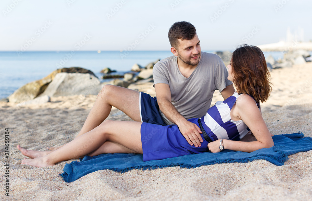 Fototapeta premium Positive loving couple resting and hugging