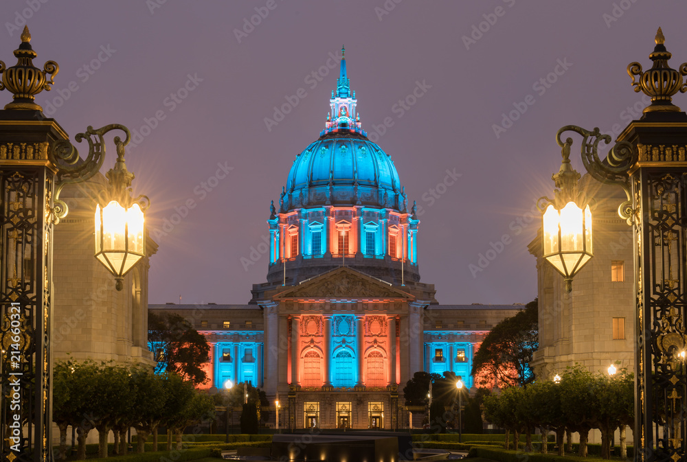 San Francisco City Hall illuminated in Turquoise and Orange. Shot from outside the War Memorial Courtyard, San Francisco, California, USA.