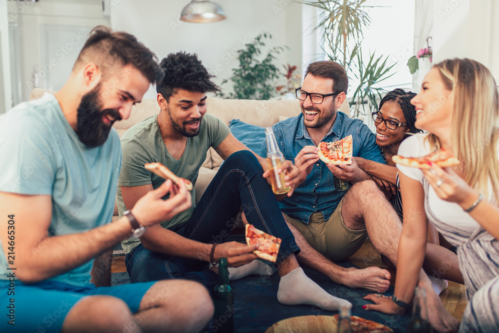 Group of young friends eating pizza.Home party.Fast food concept.