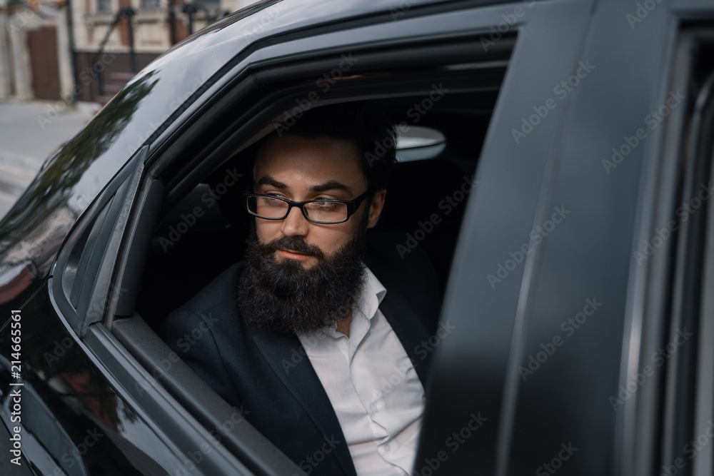 Close up portrair attractive young businessman in a car