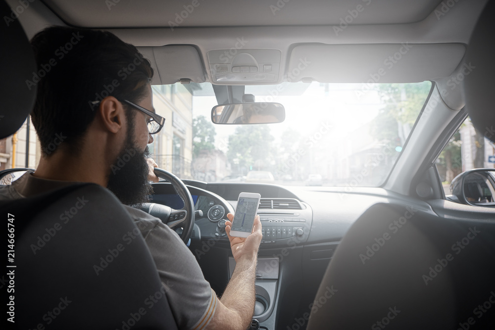 Man using mobile phone while driving.