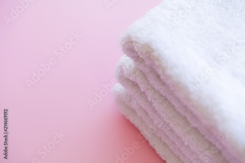 Spa. White Cotton Towels Use In Spa Bathroom on Pink Background. Towel Concept. Photo For Hotels and Massage Parlors. Purity and Softness. Towel Textile