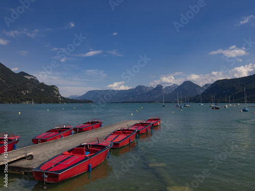 Boats in the lake in front of mountain scenery photo