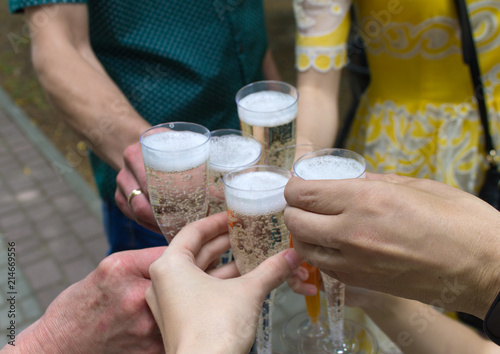 glasses with champagne in hands