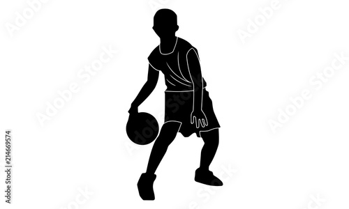 silhouette of a boy is dribbling the ball with his right hand.