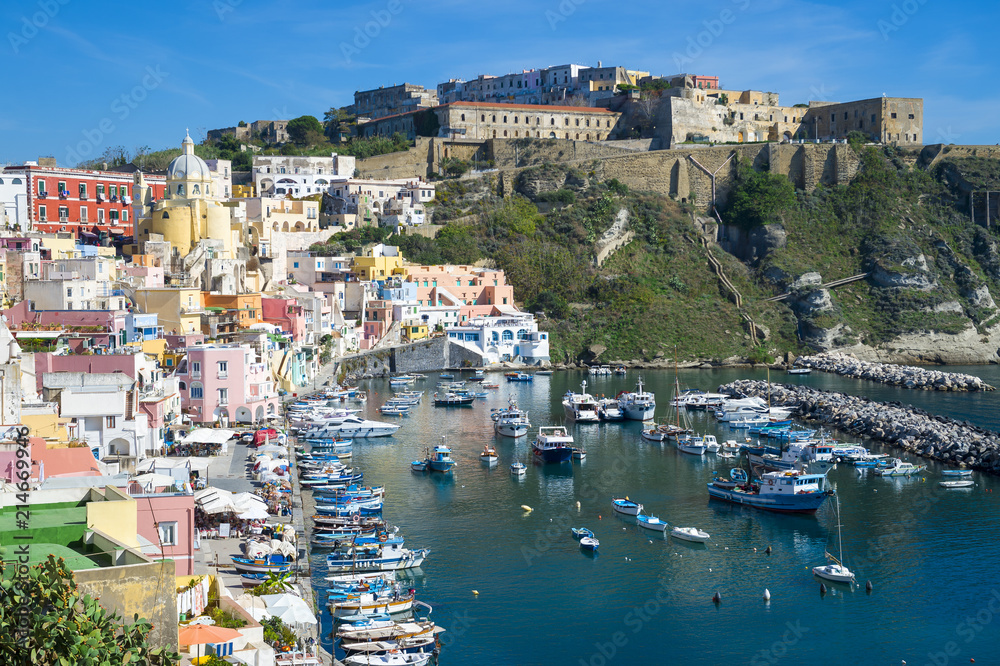 Beautiful view of traditional fishing boats moored in Corricella harbour on the island of Procida, Italy.