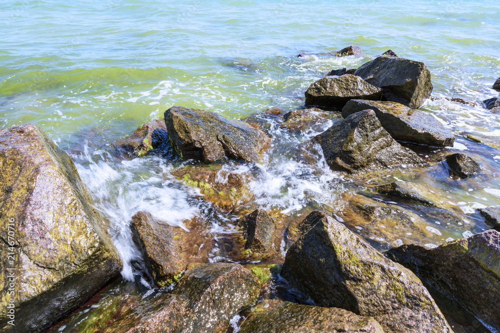 View of the Black Sea with large stones on a summer sunny day, Ukraine View of the Black Sea with large stones on a summer sunny day, Ukraine