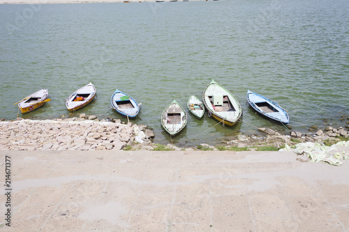 Wooden boats moored on the banks Ganges River, the holiest river in India, Varanasi photo