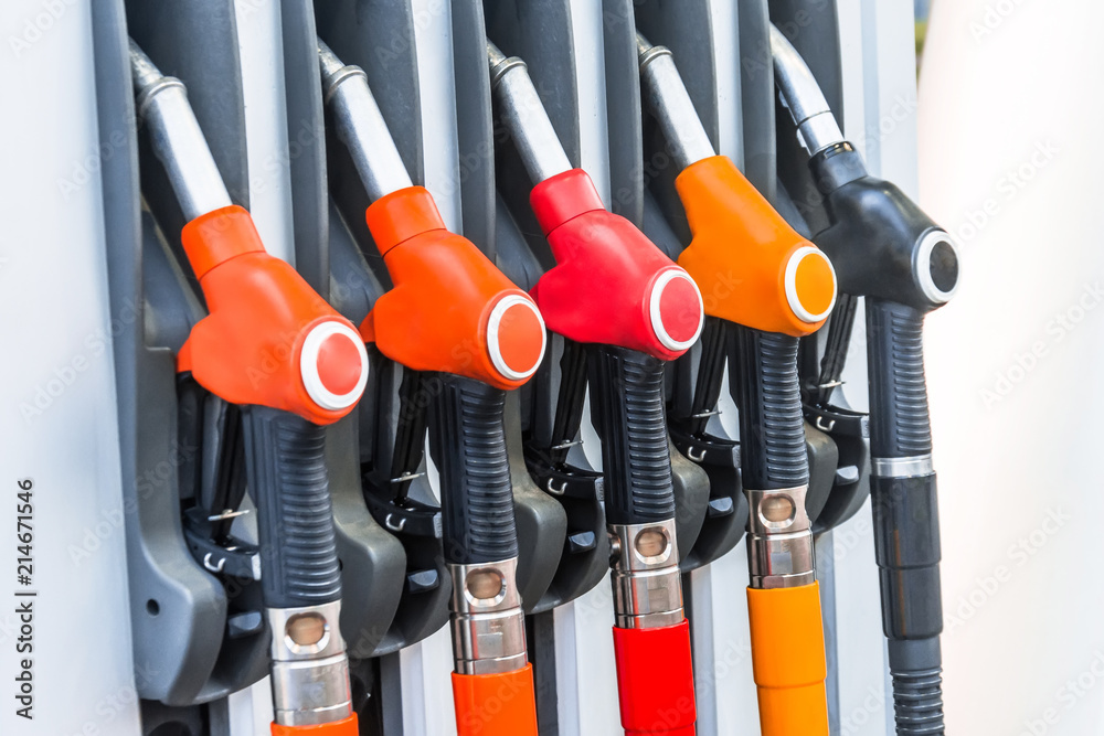 Colorful petrol pistols pump filling nozzles, refueling gas stations in a service. Colorful petrol pistols pump filling nozzles, refueling gas stations in a service.