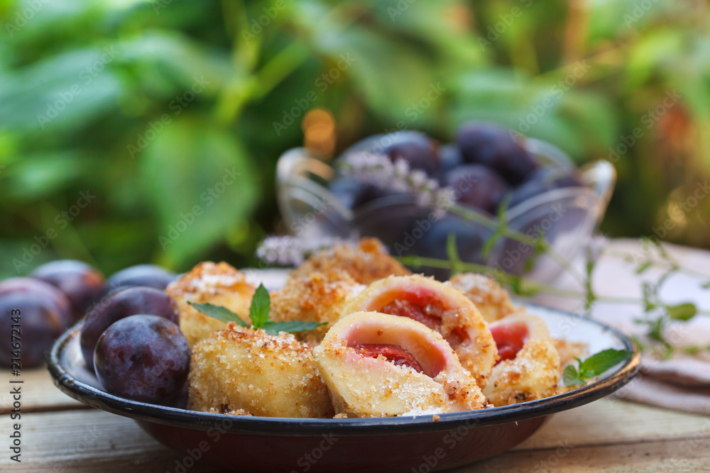 Plum dumplings coverder with breadcrumb and sprinkled with sugar. Homemade dessert with dough and plums. Plum dumplings coverder with breadcrumb and sprinkled with sugar. Homemade dessert with dough and plums.