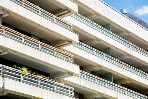 Modern apartaments in white color style with green trees.