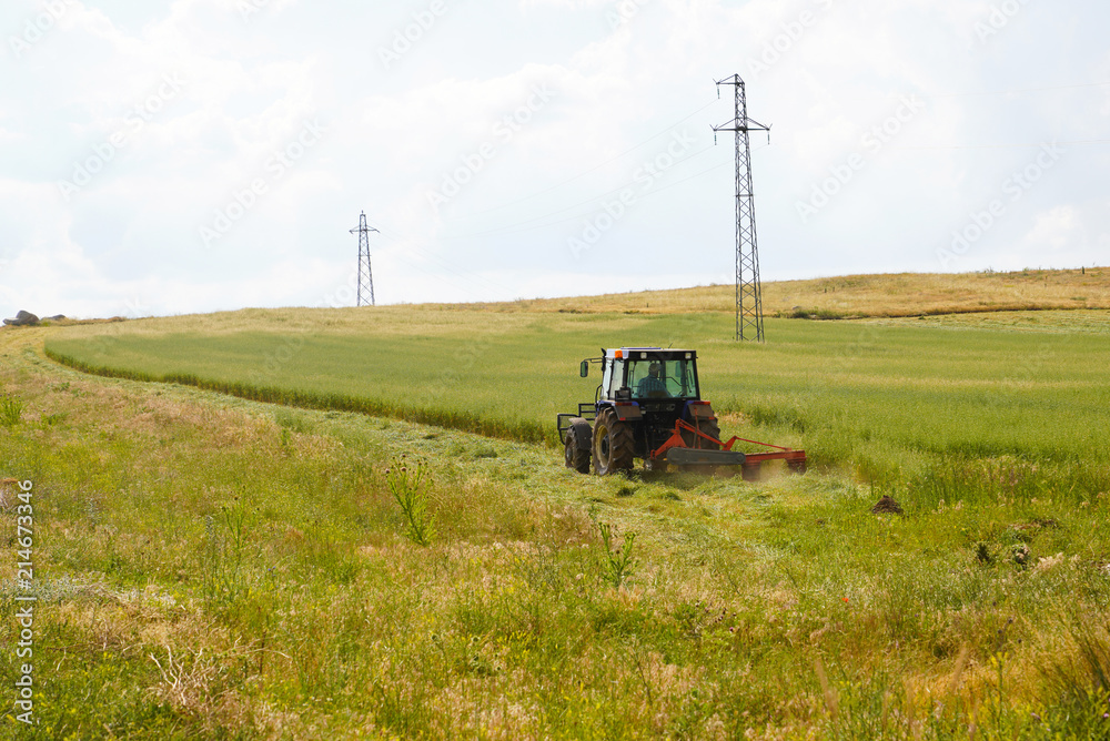 Tractor with mower cutting the meadows in Ankara, Turkey Tractor with mower cutting the meadows in Ankara, Turkey
