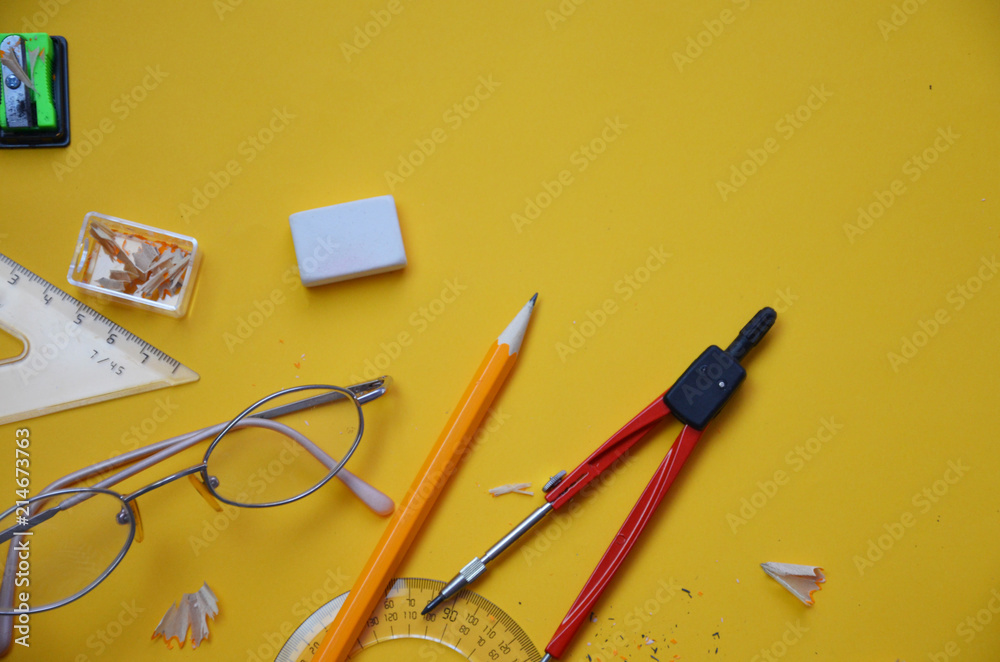Back to school set in yellow. , notebook, pen, pencils, scissors, markers, chair, clip, glasses, compass, sharpener, eraser, autumn leaves