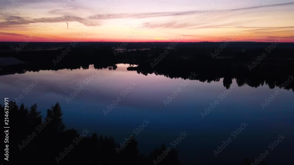 flying over a beautiful lake with a reflection of the sky and sunset flying over a beautiful lake with a reflection of the sky and sunset