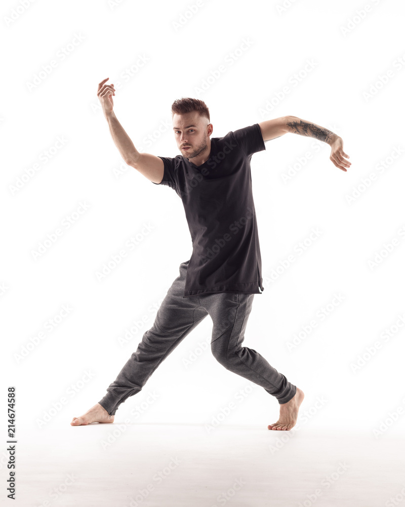 Young beautiful dancer is posing in studio