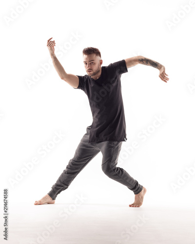 Young beautiful dancer is posing in studio