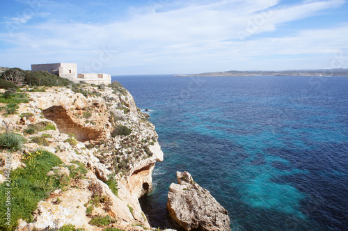 Saint Mary's Battery on Comino, Malta with cliffs and the blue sea on sunny day