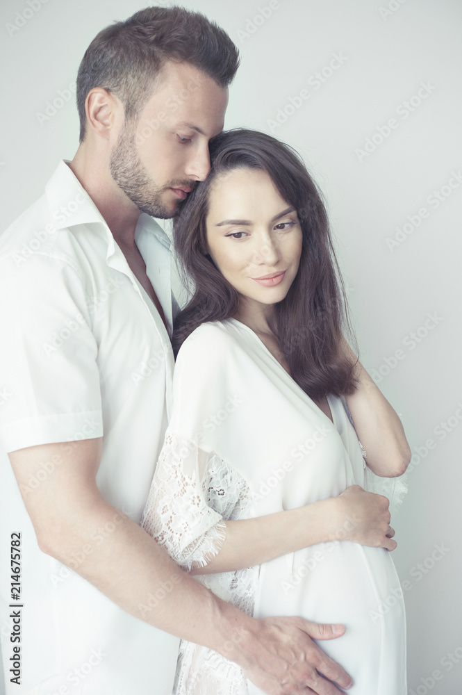 Handsome man hugging his pregnant wife Handsome man hugging his pregnant wife
