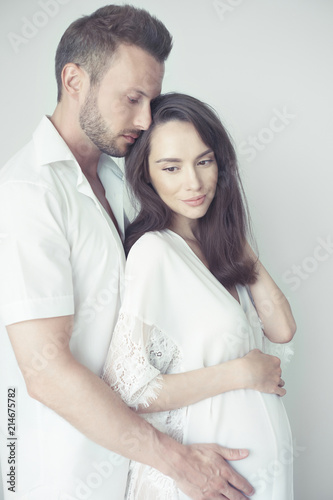 Handsome man hugging his pregnant wife