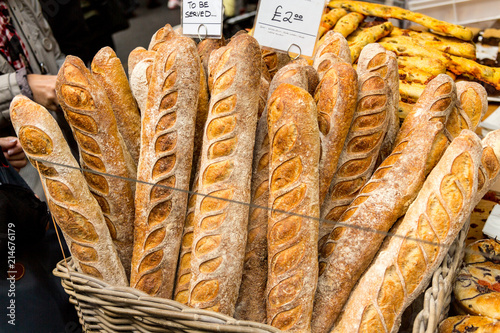 London, United Kingdom - May 2, 2015: Various loaves of breads piled up on a martket stall in Borough Market, London waiting for purchase. photo