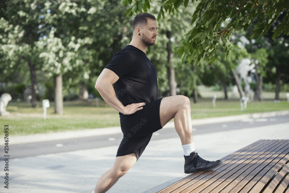 Fitness man doing lunges leg exercise outdoors.