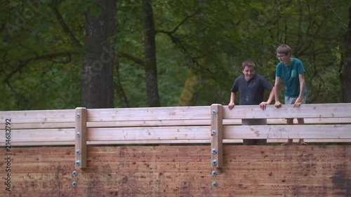 Slow-motion footage of two boys looking over and spitting over a wooden footbridge.  Shot on a Blackmagic Ursa Mini Pro 4.6k with a Sigma 50-100mm f/1.8.