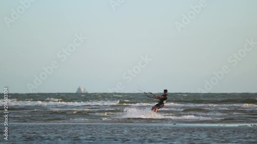 Man wakeboarding in front of Altona Beach Pier at sunset photo