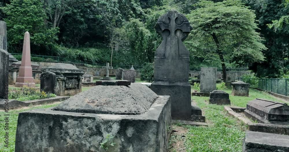 Spooky headstones of old cemetery with many graves and antique tombs. Mystery and silence of spooky landscape Spooky headstones of old cemetery with many graves and antique tombs. Mystery and silence of spooky landscape