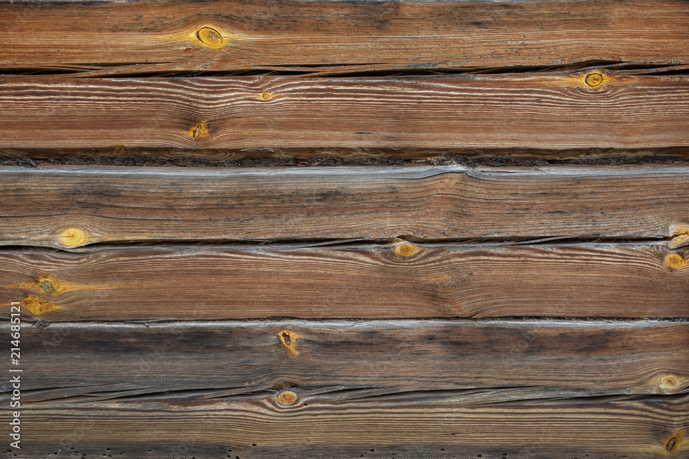 Fototapeta premium A log house wall with close up log texture. Outside exterior.