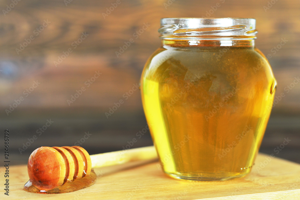 Honey jar with wooden honey dipper Honey jar with wooden honey dipper