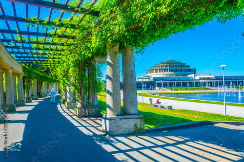 An arcade covered with plants circulating fountain at Stulecia hall in Wroclaw, Poland photo