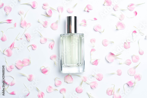 Perfume bottles and pink carnations on white background