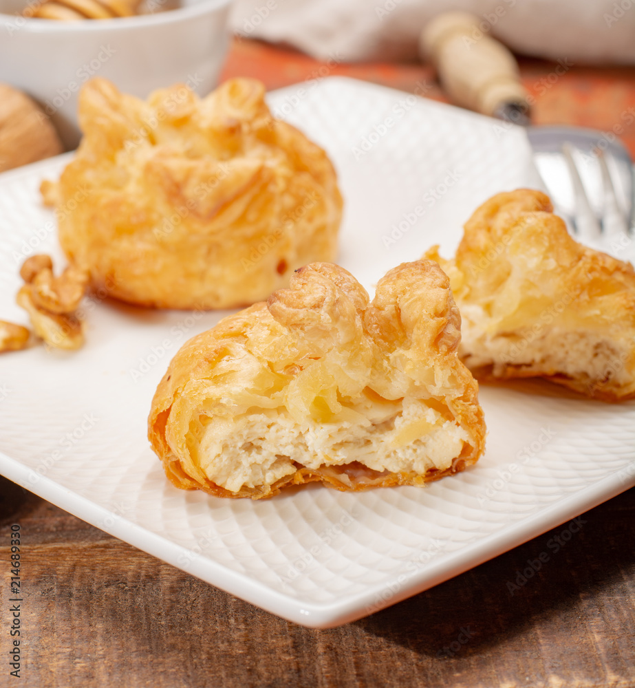 French snack pouches made from puff pastry with fresh soft goat cheese and honing French snack pouches made from puff pastry with fresh soft goat cheese and honing