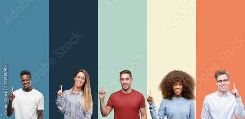 Group of people over vintage colors background showing and pointing up with finger number one while smiling confident and happy. photo
