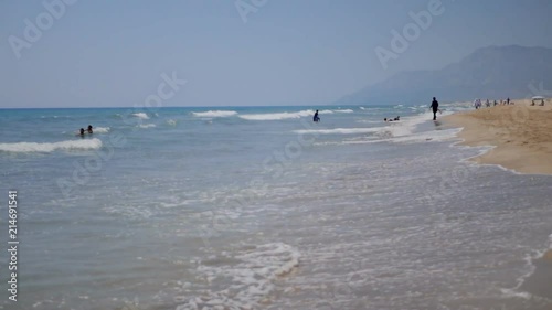 Long sea waves covering sand beach in Patara, Turkey photo